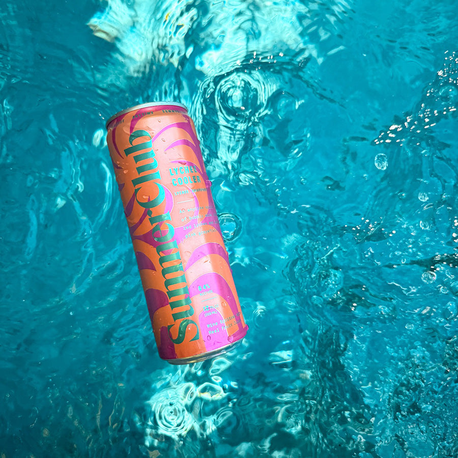 Lychee Cooler can floating in clear blue water