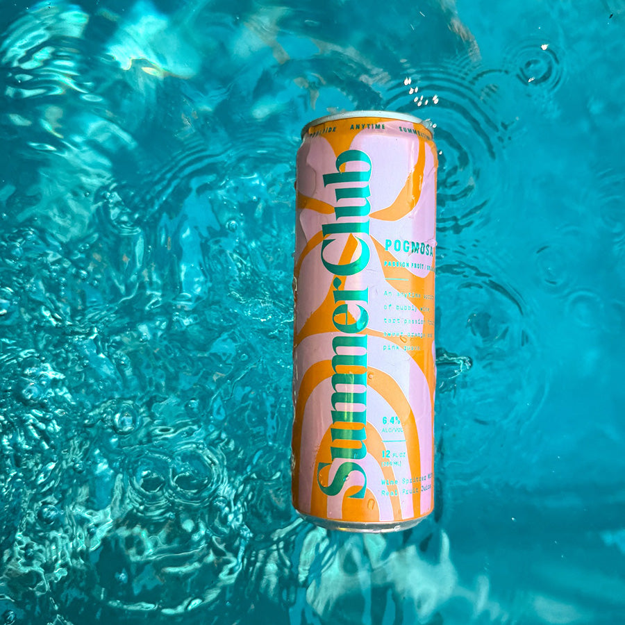 Can of Pogmosa floating in clear blue water.